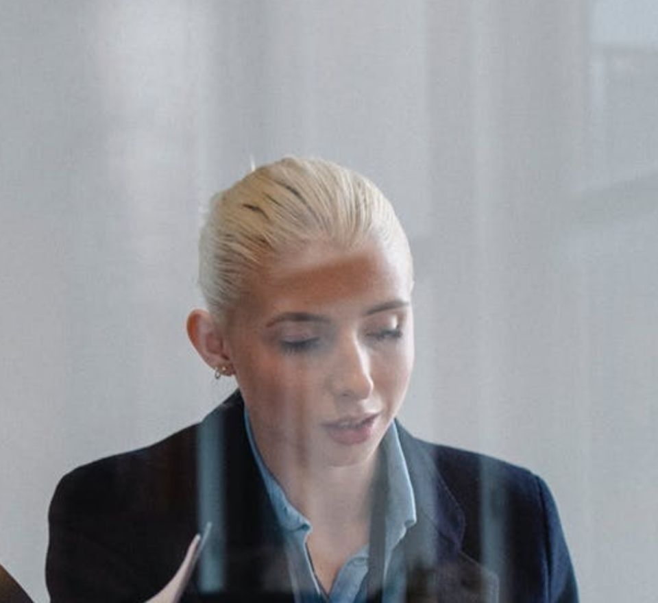 Woman looking down as she reads some project information